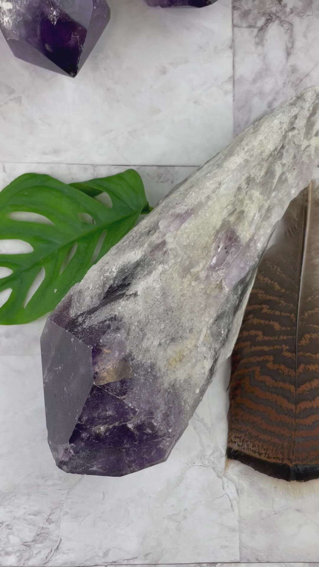 video of elestial amethyst points on a marble background