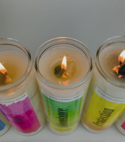 Video of different candles lit up surrounded by crystals and flowers