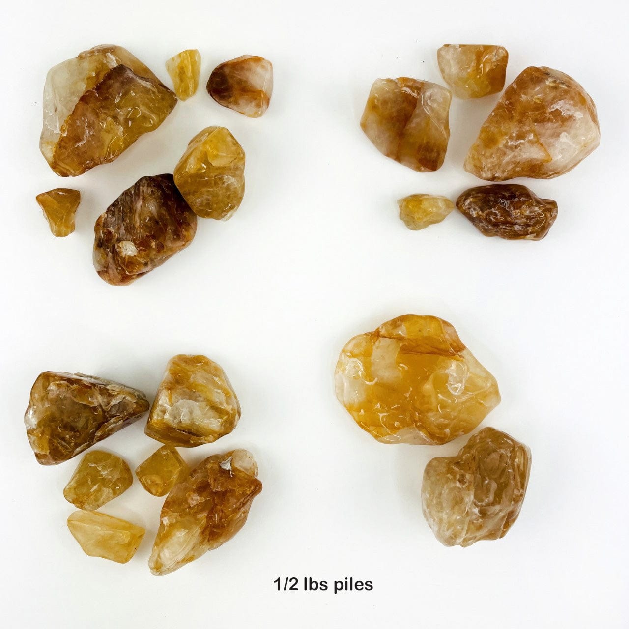 1/2 pound piles of Golden Healer Quartz Polished Tumbled Stones