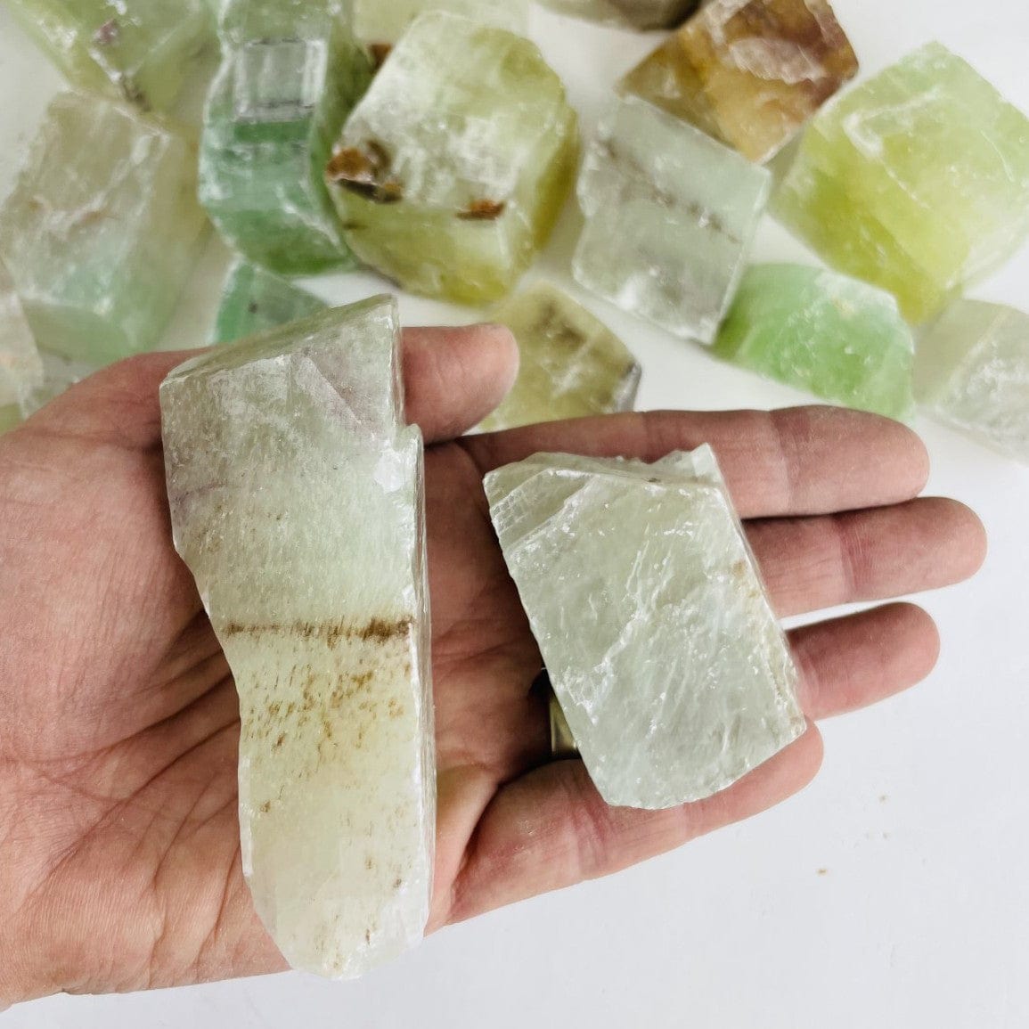 Green Calcite Stones in hand for size