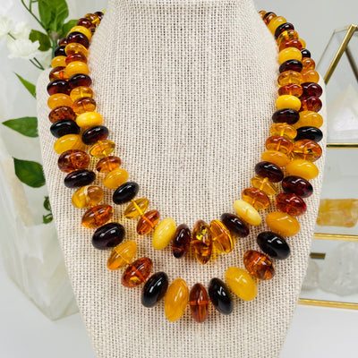 amber bead necklaces displayed to show the differences in the two options 