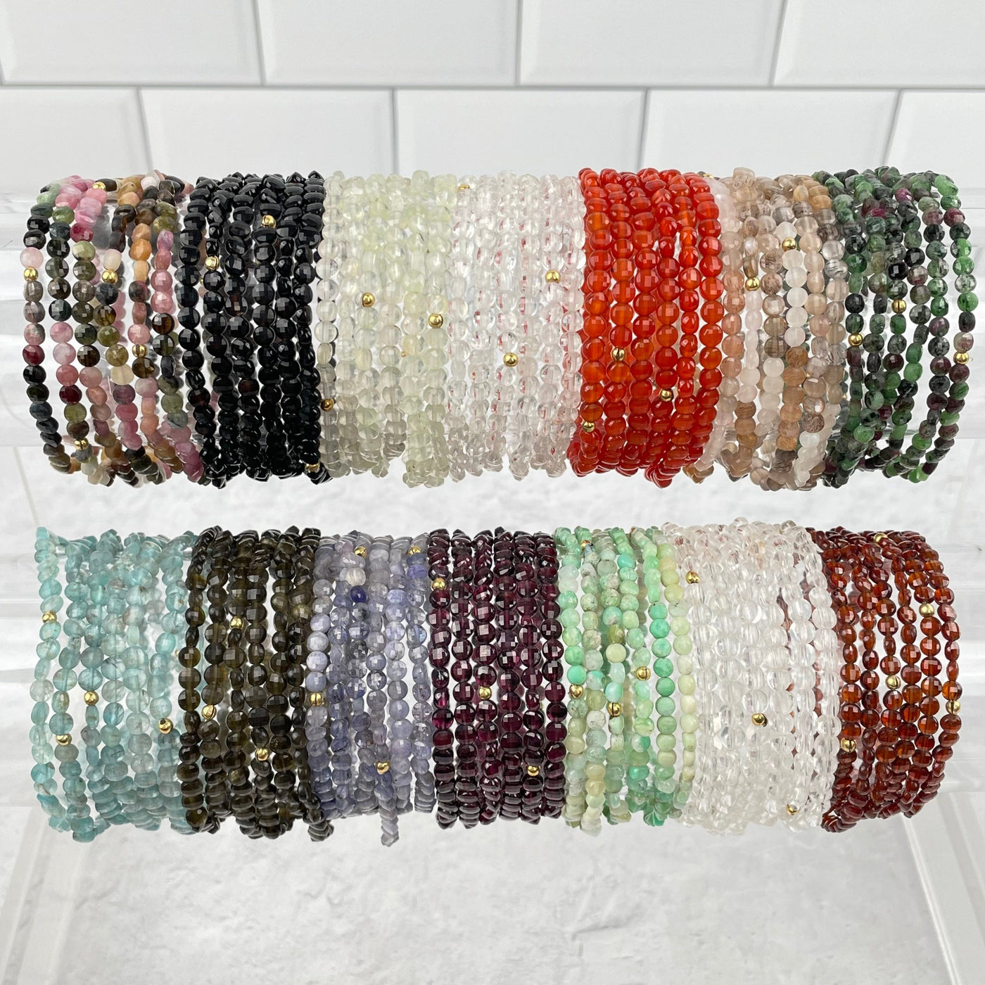 multiple Faceted Coin Bead bracelets displayed to show the differences in the crystal options 