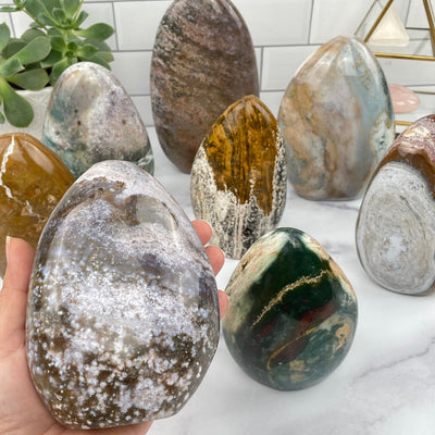 Ocean Jasper Polished Cut Base in hand for size reference 