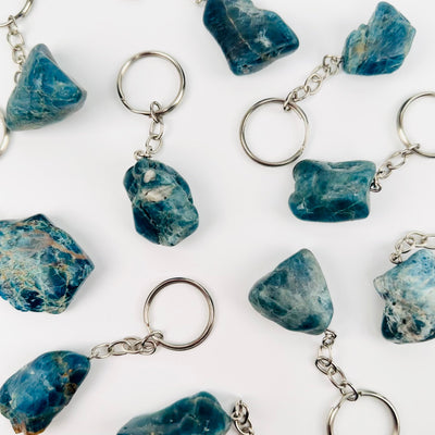 multiple apatite silver toned keychains on white background