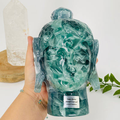 buddha carved out of fluorite in hand for size reference 