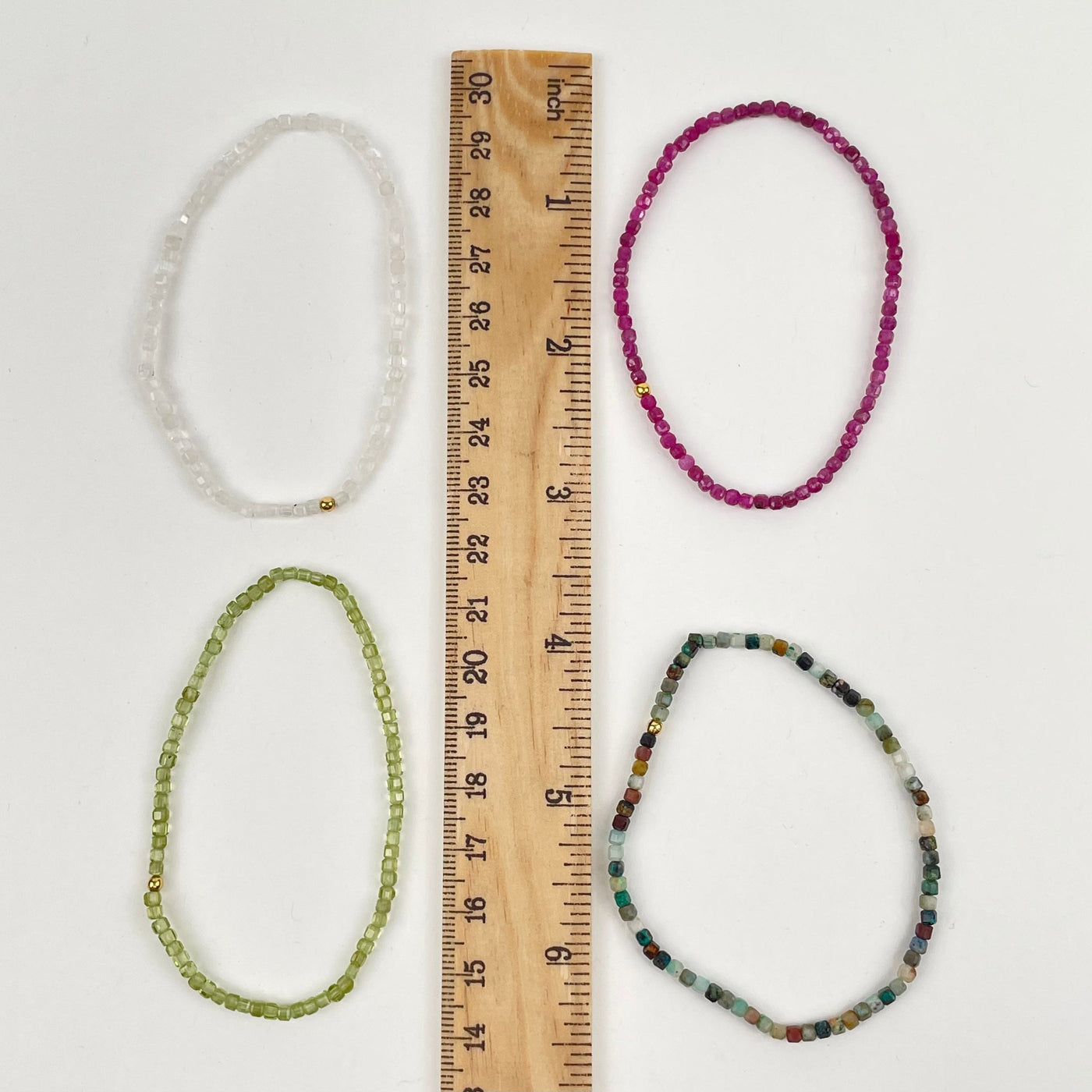 bracelets displayed next to a ruler for size reference 