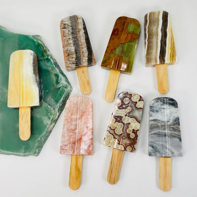 multiple mexican onyx popsicles displayed to show the differences in the stone colors 