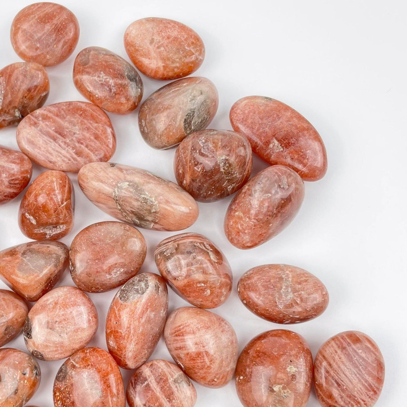 Golden Sunstone Tumbled Stones displayed for size reference 