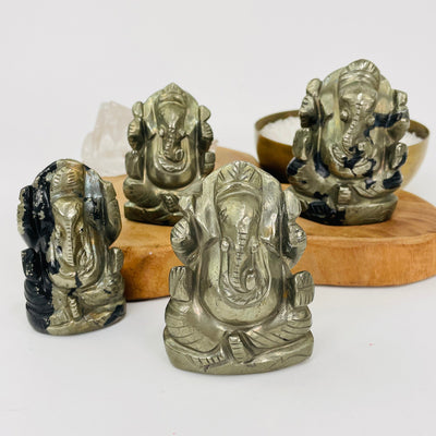 engraved pyrite ganesha displayed to show the differences in the sizes and color shades 
