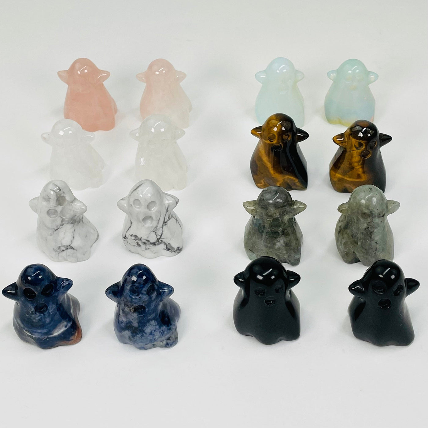 multiple carved gemstone ghost displayed to show the differences in the stone types and colors