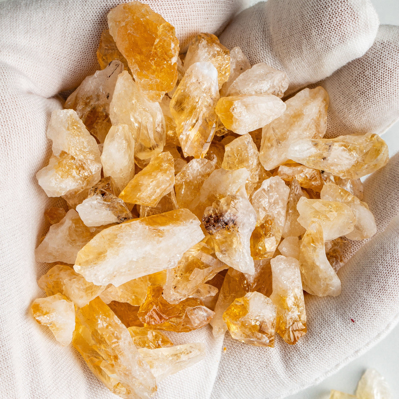 Citrine Stones - Golden Amethyst in a hand, approximately 150 grams, 1 bag