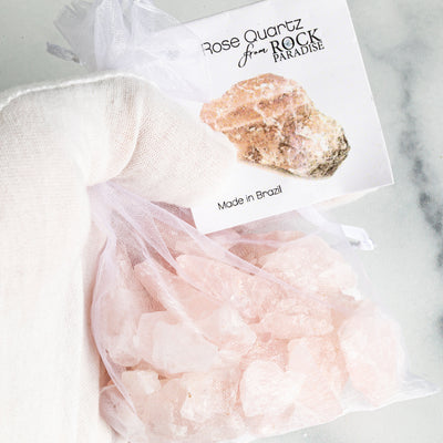 Rose Quartz Stones - Tied & Tagged in an Organza Bag in a hand up close