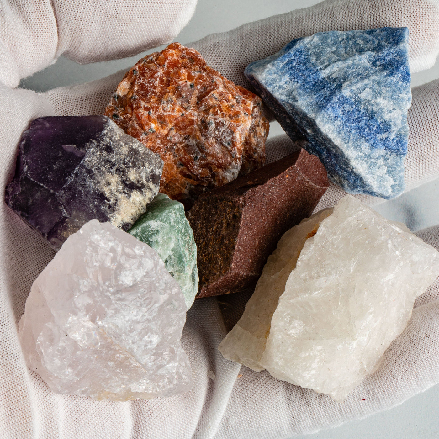 Healing Stone Set - 7 Rough Chakra Stones in a hand