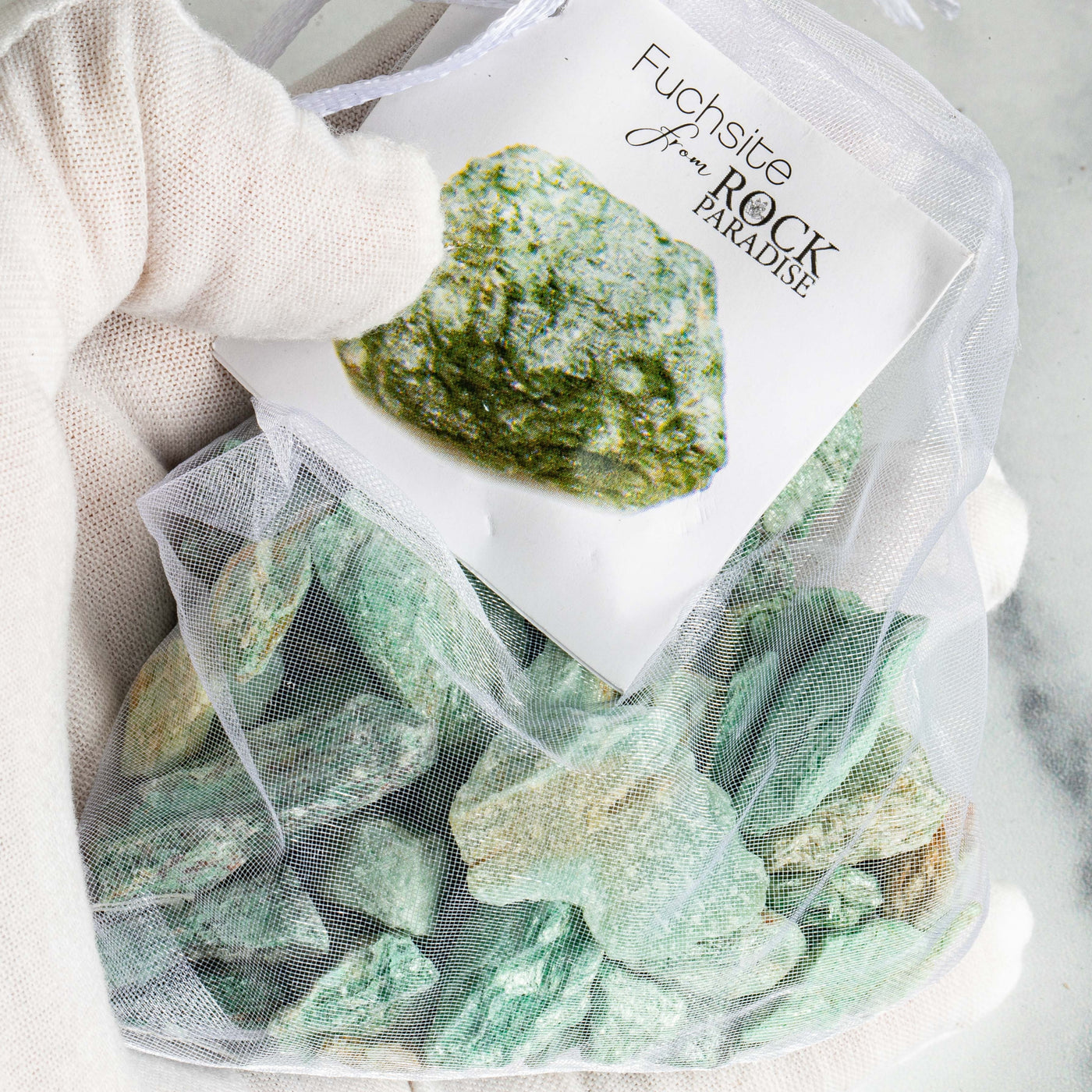Fuchsite Stones - Tied & Tagged in an Organza Bag up close in a hand