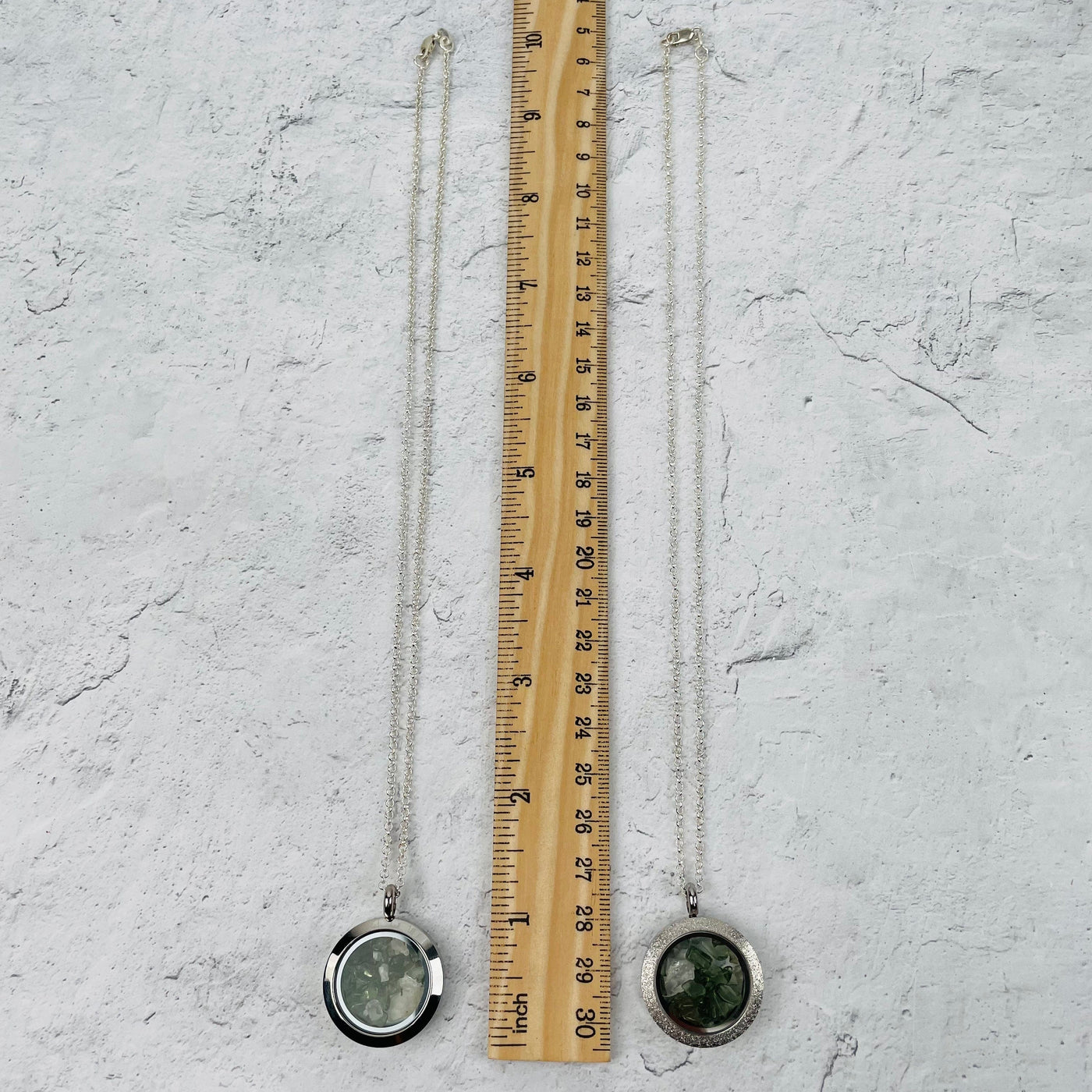 necklaces next to a ruler for size reference. comes on an 18" chain 