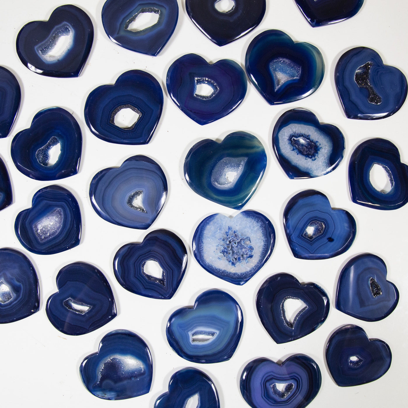 Blue Heart Shaped Agates displayed to show various colors and characteristics with stripes and druzy centers