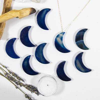 Multiple Blue Drilled Half Moon Agate With Necklace on White Background