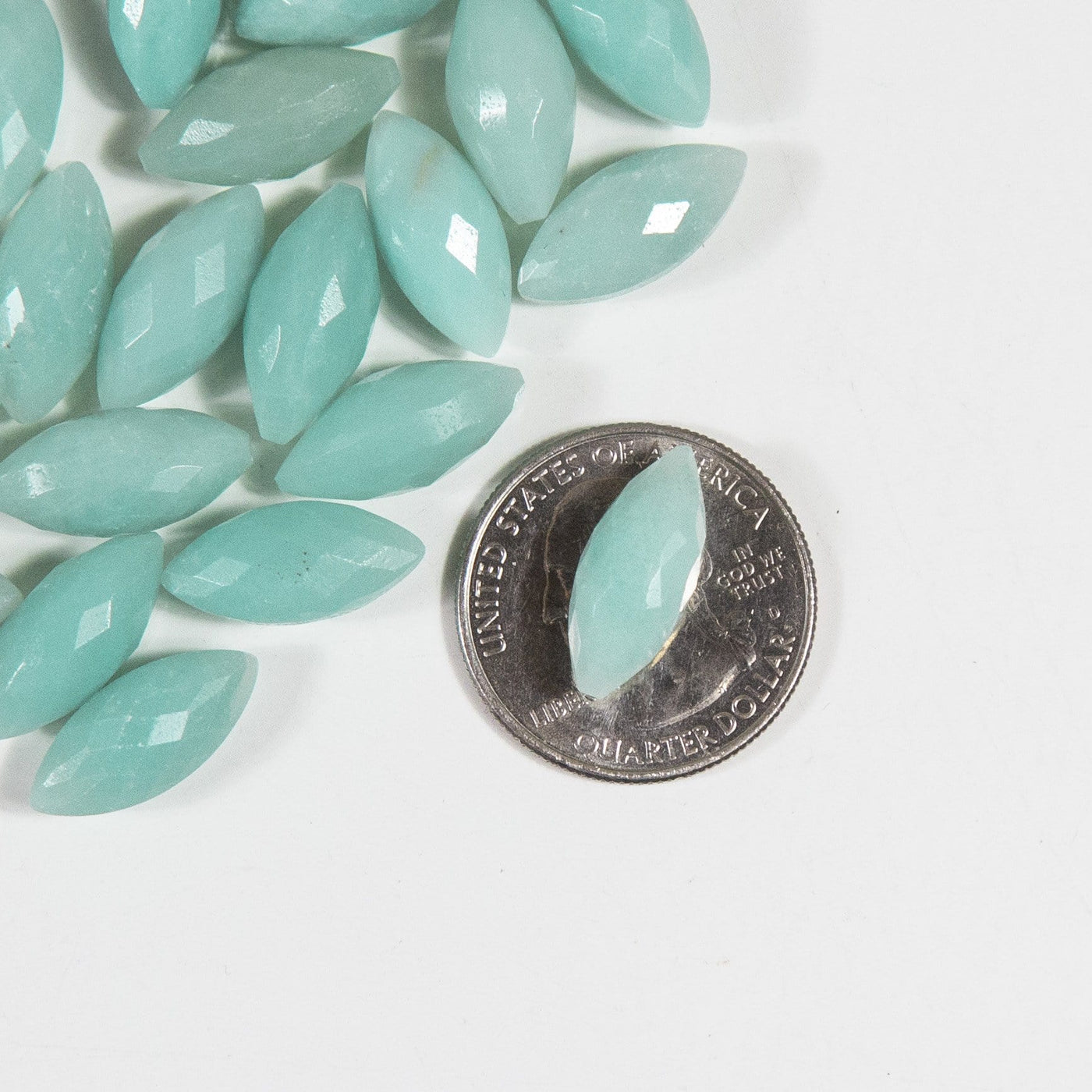 Picture of amazonite facted cabochon on top of a quarter for size reference. 