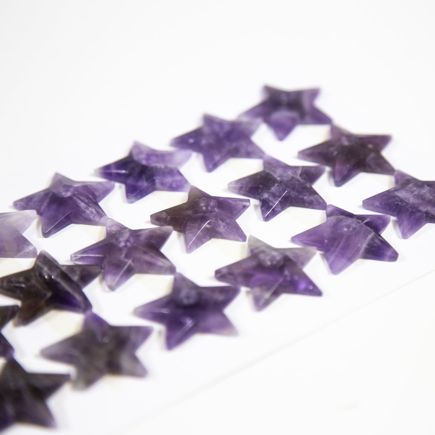 up close shot of amethyst star cabochons on white background