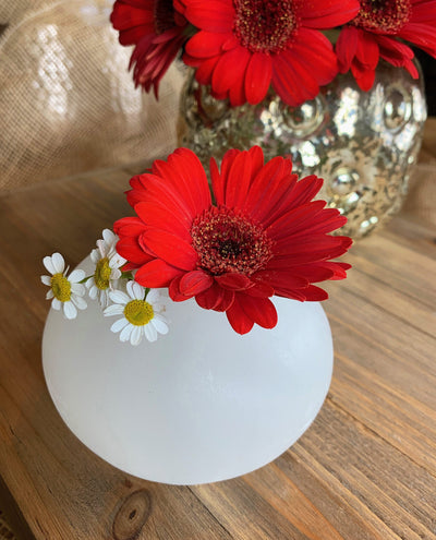 Selenite Sphere Candle Holder  holding a couple flowers