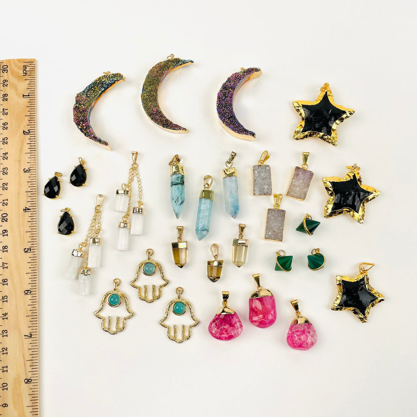 pendants displayed next to a ruler for size reference 