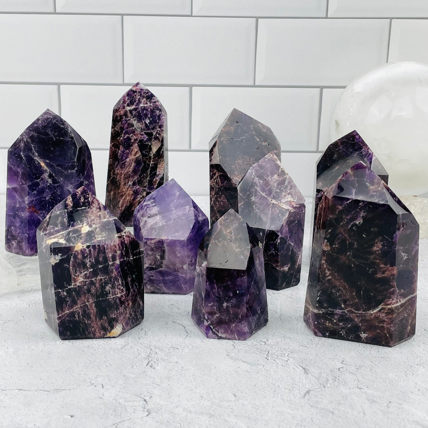 multiple deep purple amethyst points displayed to show the differences in the the sizes and color shades.
