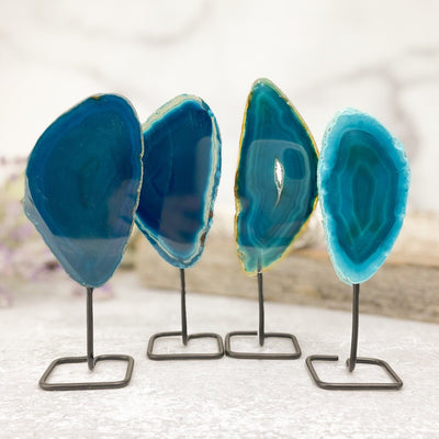 Four of the teal agate on metal stand are being shown in this picture.