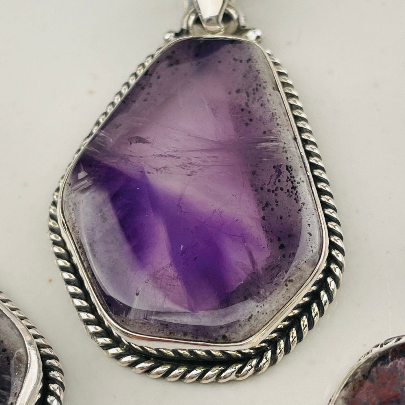 close up of the details on this Trapiche Amethyst with Matrix pendant
