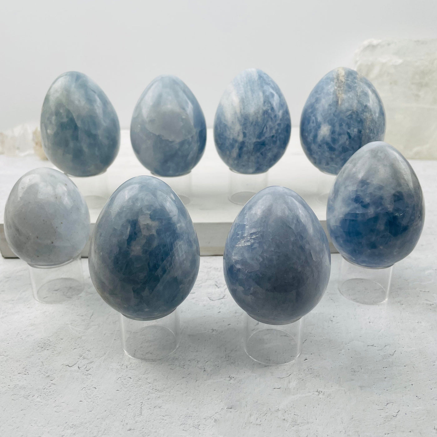 multiple blue calcite eggs displayed to show the differences in the sizes and color shades 