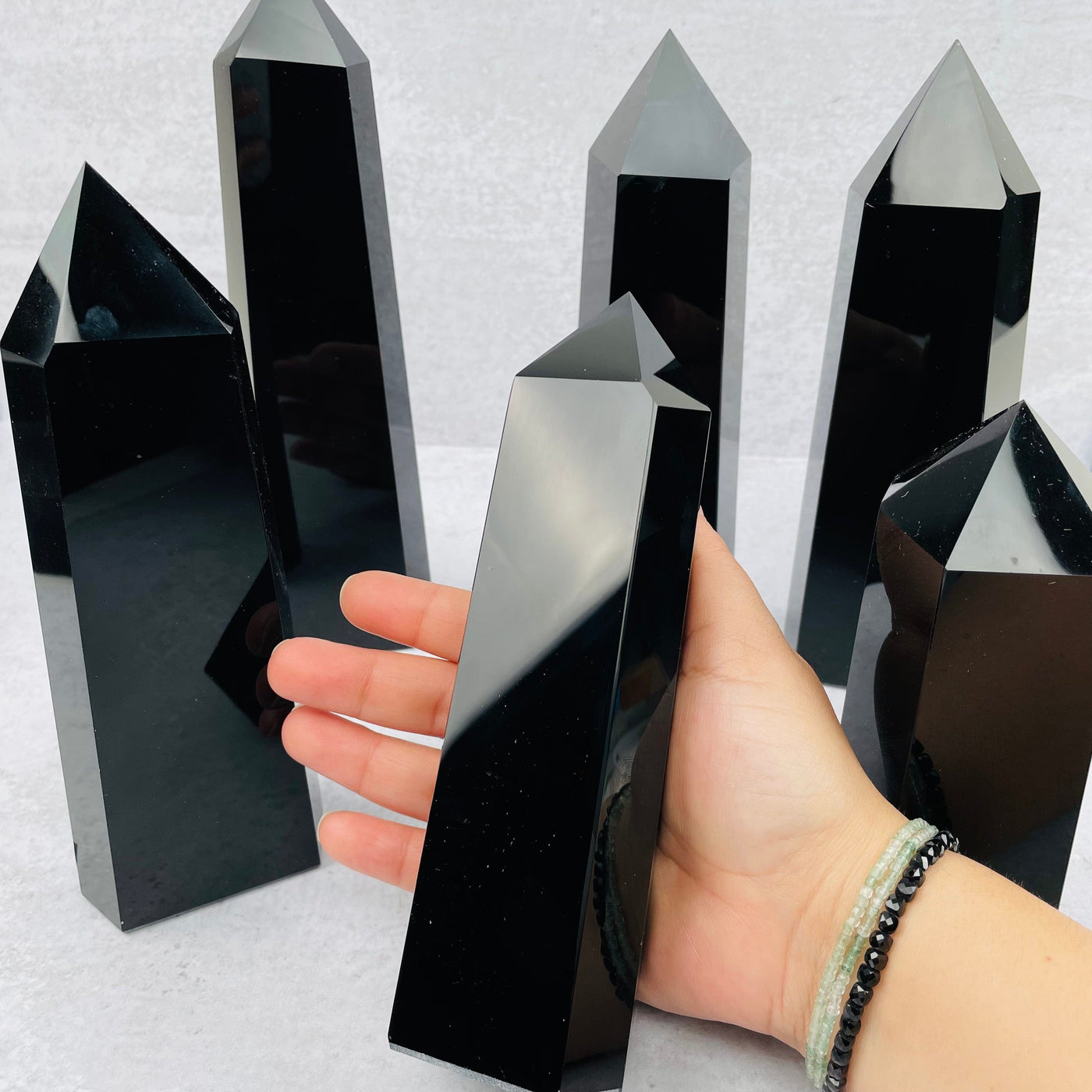 multiple black obsidian points displayed to show the differences in the sizes available 