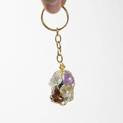 close up of one seven stone chakra tumbled stone gold keychain for details