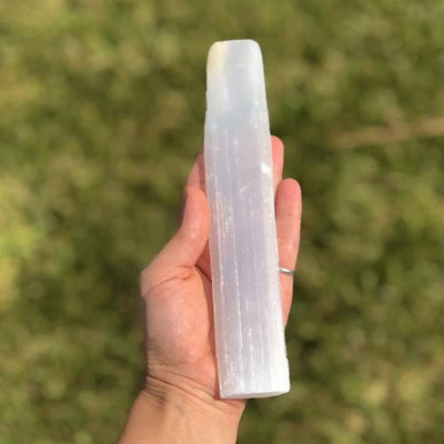 Chakra and Selenite Charging Set--stone in hand showing detail and size comparison with hand.
