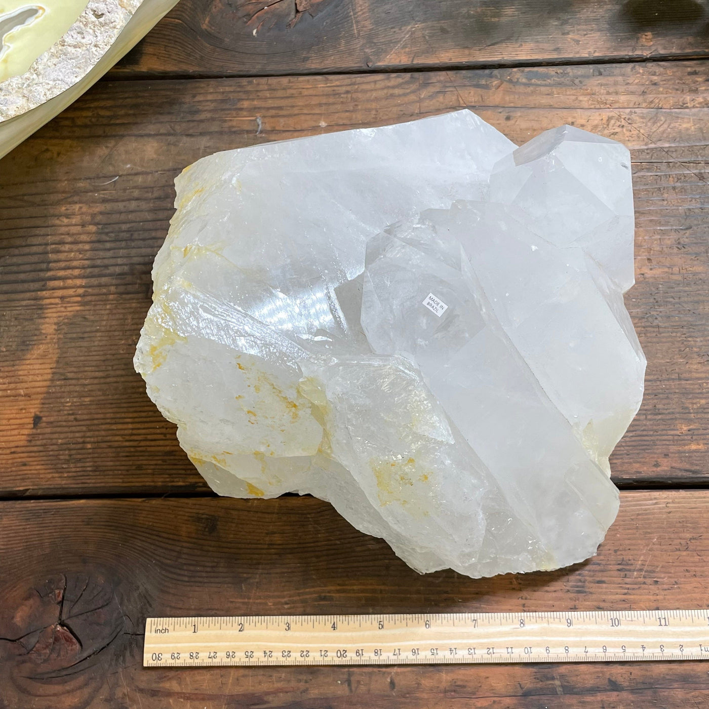 crystal cluster next to a ruler for size reference 