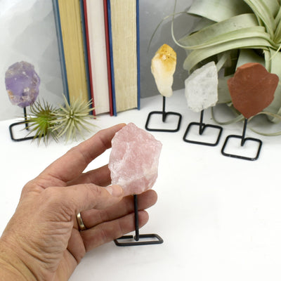 Natural Crystal Decor - Rough Stone on Metal Stand - rose in a hand