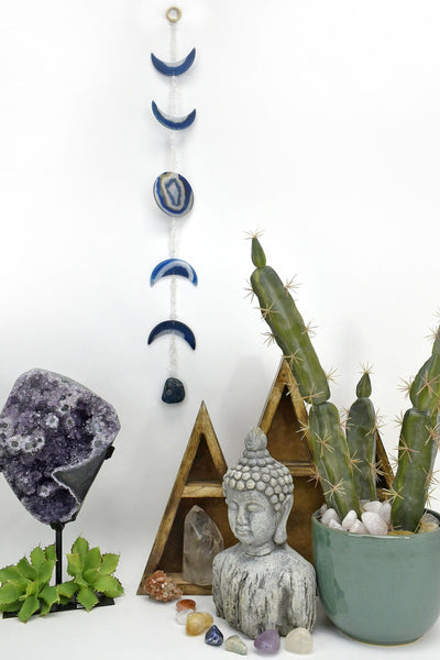 One blue agate moon phase wall hanging hung with a white background. within an alter