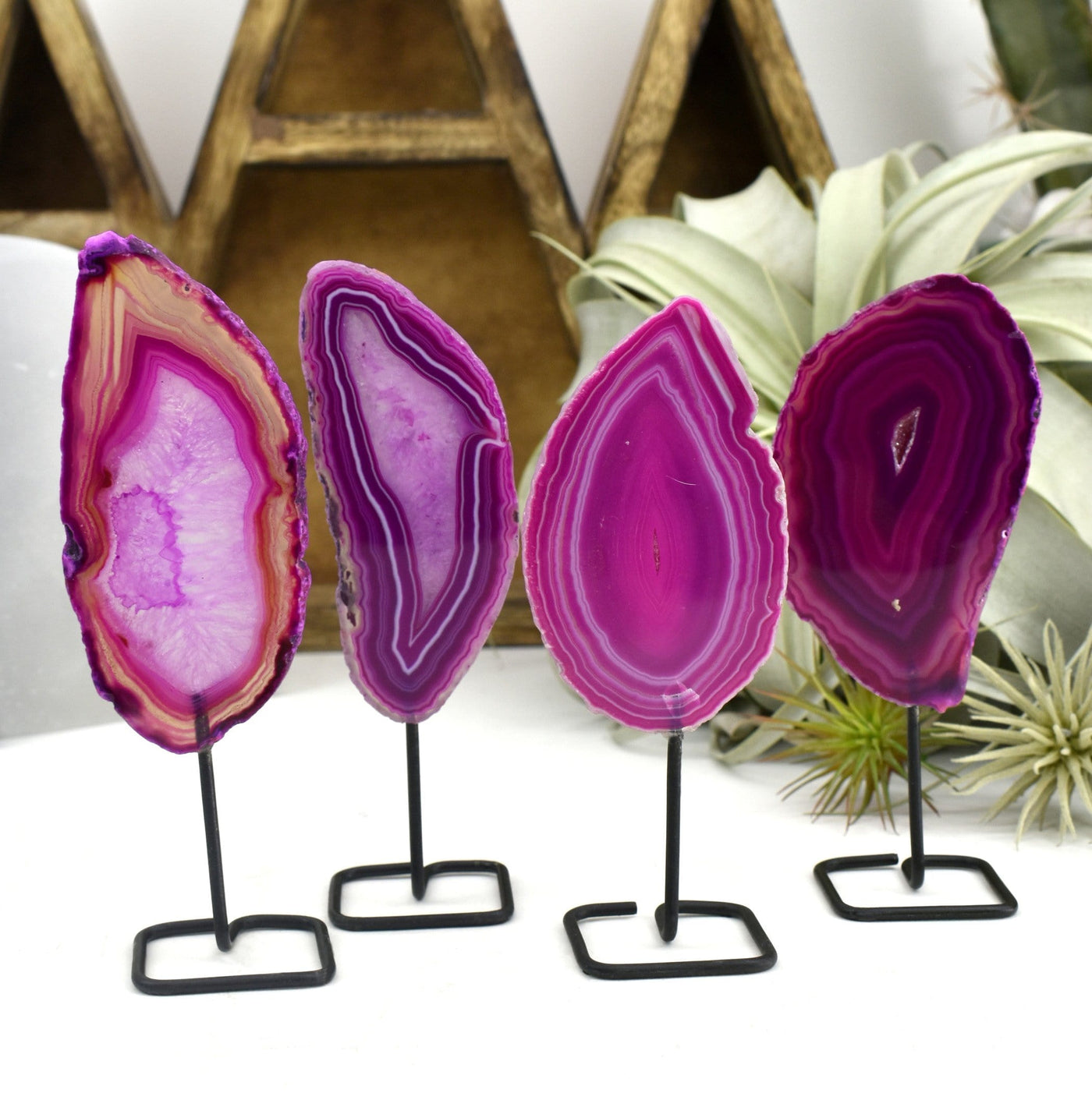 Four of the pink agate on metal stand are being shown in this picture.