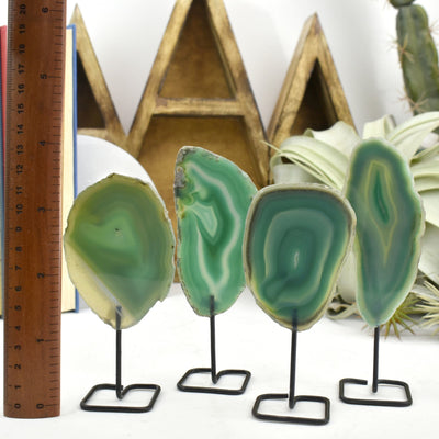 Four of the green agate on metal stand are being shown in this picture.