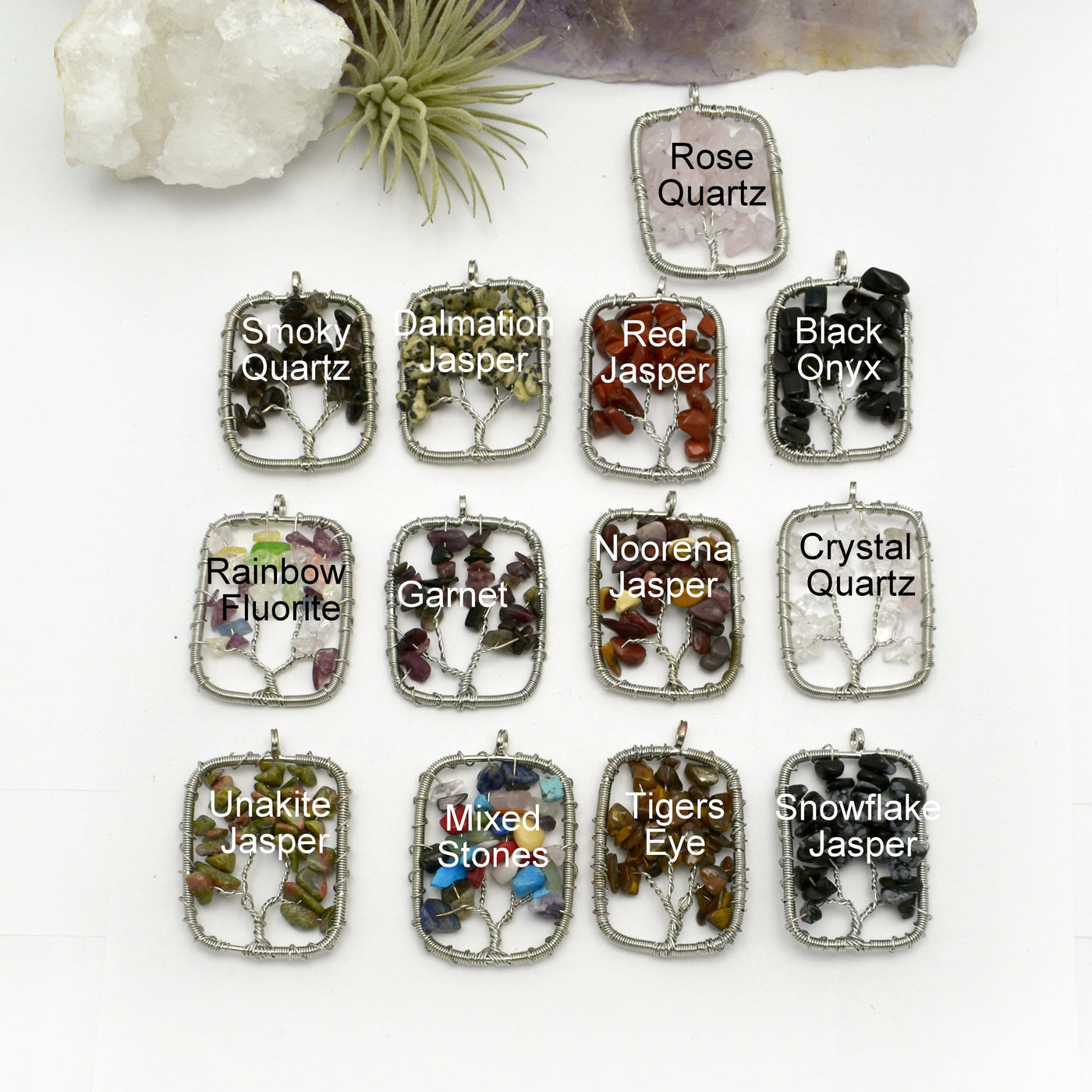 13 tree of life pendants labeled with respective crystal variation on white background with decorations