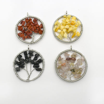 4 Tree of Life Pendants in different crystals on white background
