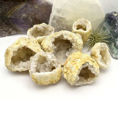 7 White Druzy Geodes with decorations in the background