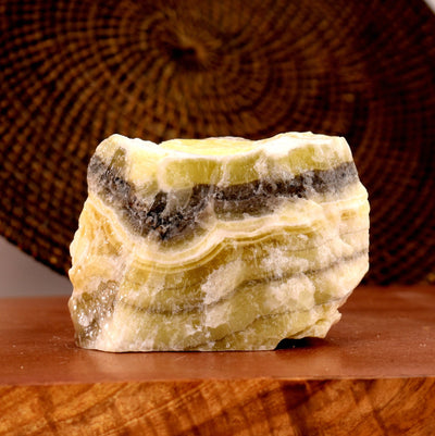 Mexican Onyx Rough Stone with decorations in the background