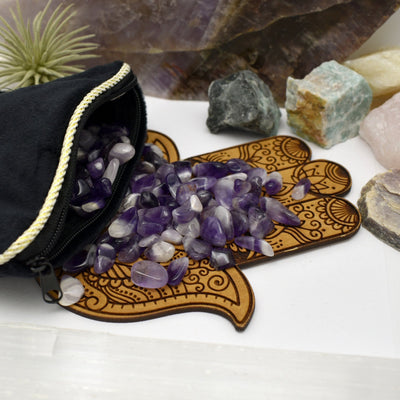 Energetic Pillow filled with amethyst tumbled stones on white background.