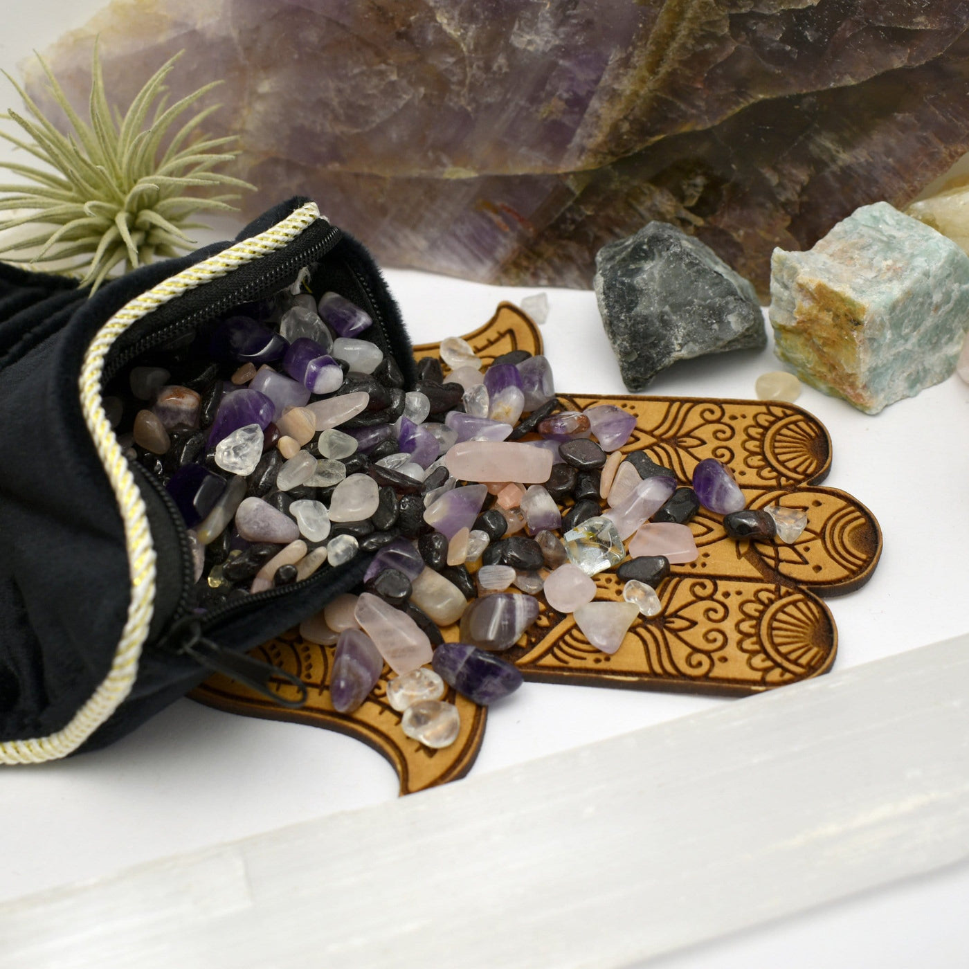 Energetic Pillow filled with amethyst tumbled stones on white background.