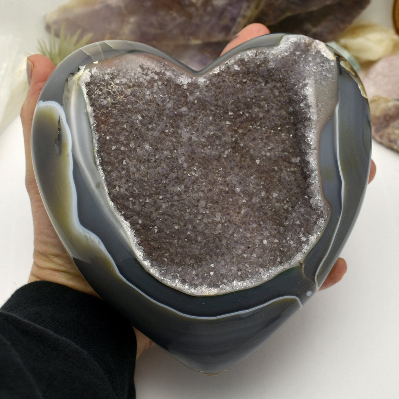 Close up of Agate Druzy Polished Heart (DOOAK-S24-18) in a hand. 