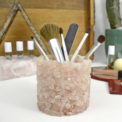 A rose quartz Tumbled Stone Pot Holder with make up brushes in it to see it can be used for many items 