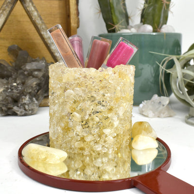 A citrine Tumbled Stone Pot Holder with lip glass in it 