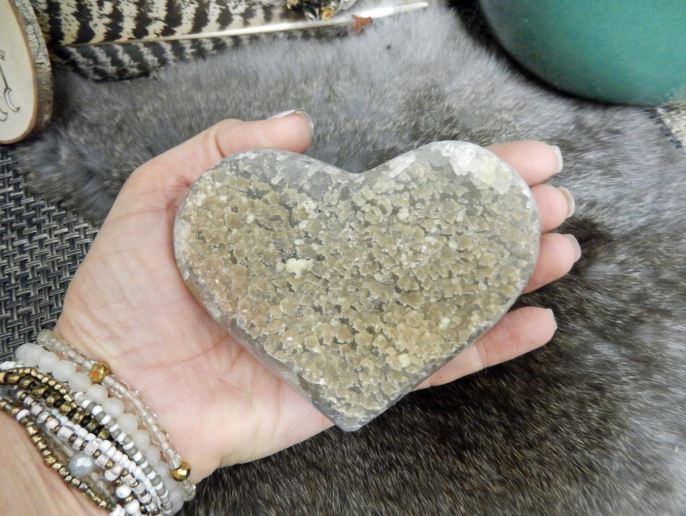 hand holding up agate heart 