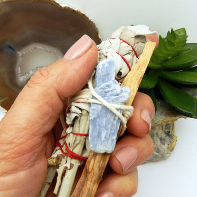 sage bundle with blue kyanite in hand for size reference and possible variation
