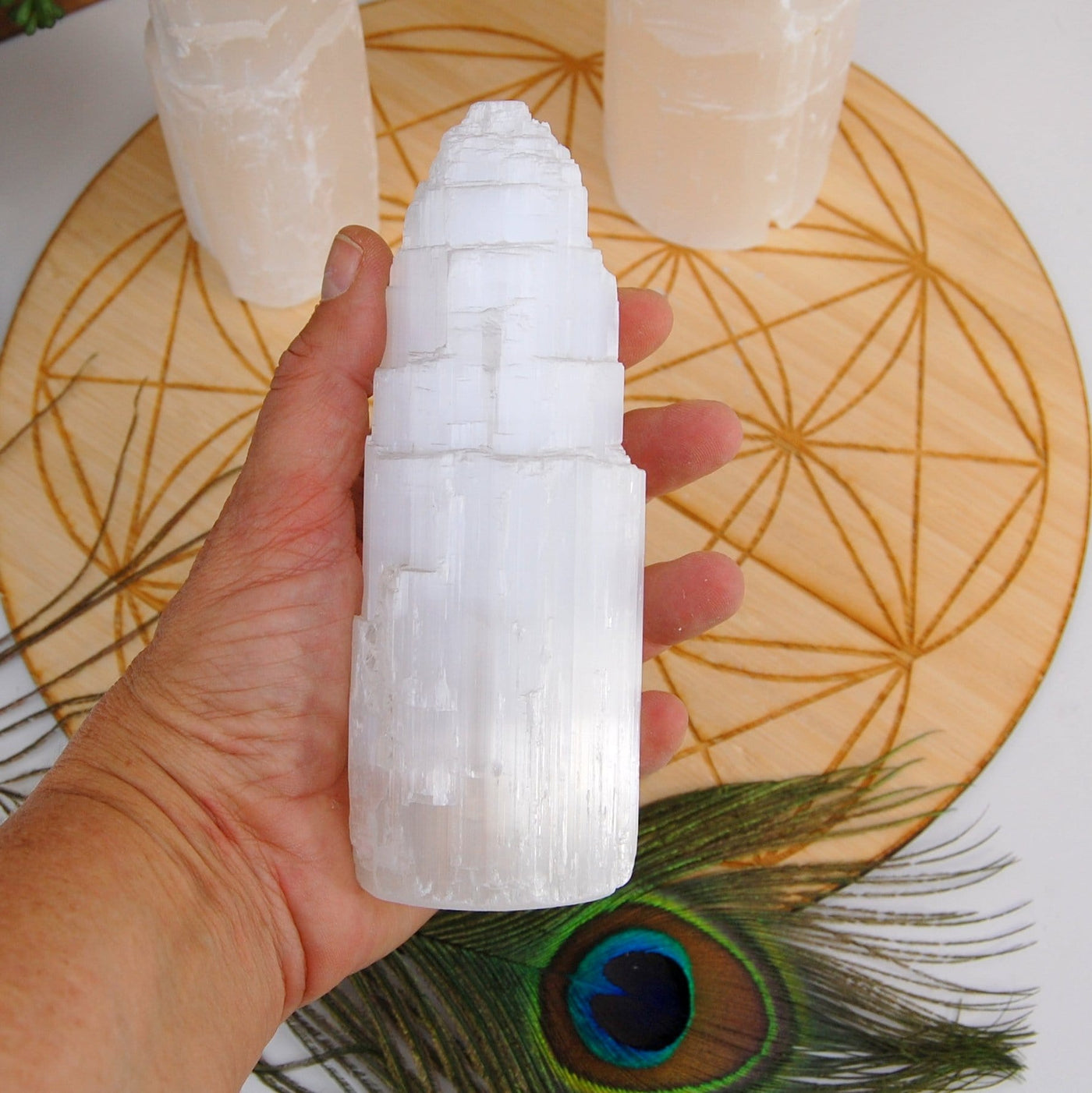 selenite raw crystal tower light in hand for size reference
