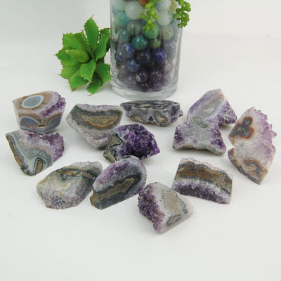 multiple Amethyst Stalactite Paper Weights displayed on white background